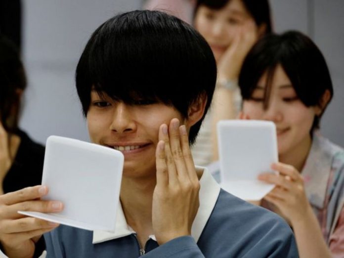 japanese people getting lesson how to smile again without mask